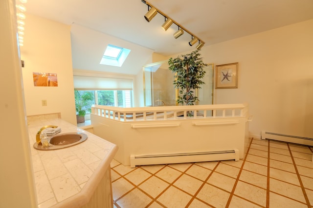 58 Bunker Ln Unit 3, Lincoln, NH 03251 - bathroom featuring a baseboard heating unit, a skylight, a shower, lofted ceiling, and vanity