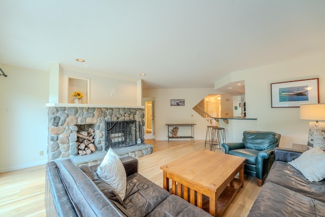 58 Bunker Ln Unit 3, Lincoln, NH 03251 - living room with light wood-style floors, a stone fireplace, and recessed lighting