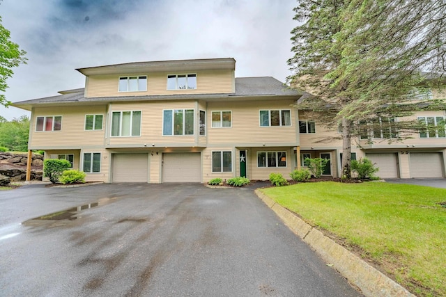 58 Bunker Ln Unit 3, Lincoln, NH 03251 - view of property featuring an attached garage, driveway, and a front yard