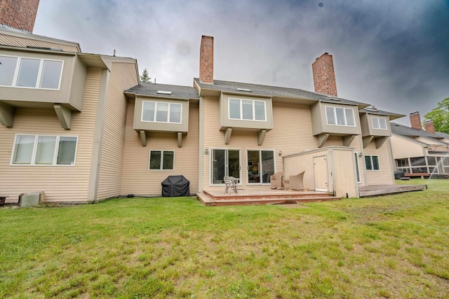 58 Bunker Ln Unit 3, Lincoln, NH 03251 - rear view of property featuring a wooden deck, a chimney, and a lawn