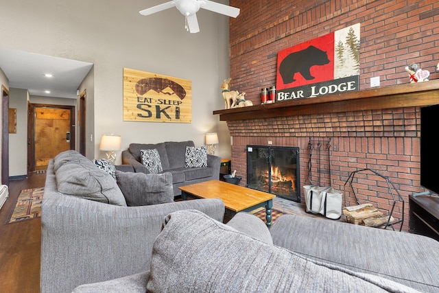 105 Timberline Rd S Unit L8, Killington, VT 05751 - living room featuring a high ceiling, wood finished floors, a fireplace, ceiling fan, and brick wall