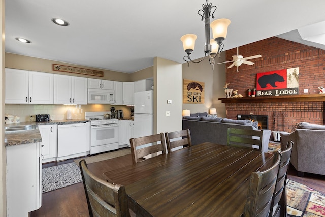 105 Timberline Rd S Unit L8, Killington, VT 05751 - dining room with ceiling fan, dark wood finished floors, a fireplace, brick wall, and a chandelier