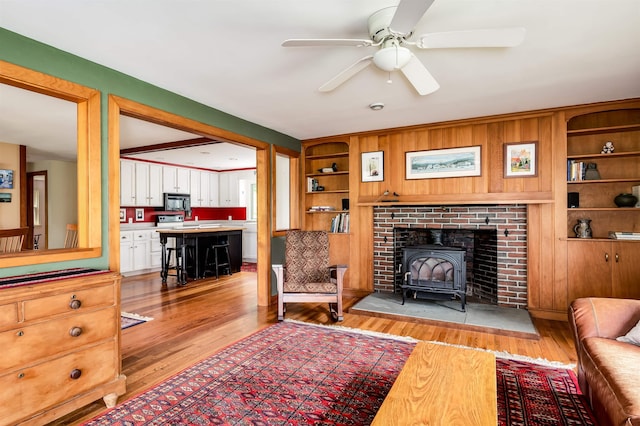 30 Old Piscataqua Rd, Durham, NH 03824 - living area with a wood stove, light wood-type flooring, ceiling fan, and built in features
