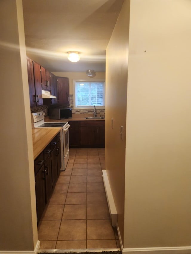17 Burns Ave Unit 2, Concord, NH 03301 - kitchen with electric stove, light tile patterned flooring, light countertops, under cabinet range hood, and tasteful backsplash