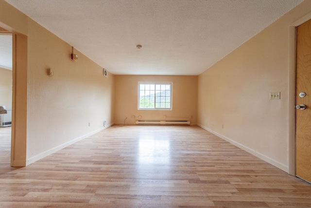 30 Beech St Unit 4B, Bristol, NH 03222 - unfurnished room featuring light wood finished floors, baseboard heating, and a textured ceiling