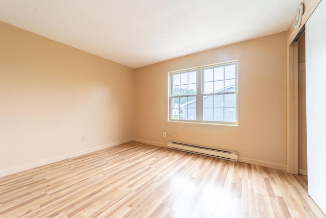 30 Beech St Unit 4B, Bristol, NH 03222 - spare room with a baseboard heating unit and light wood finished floors