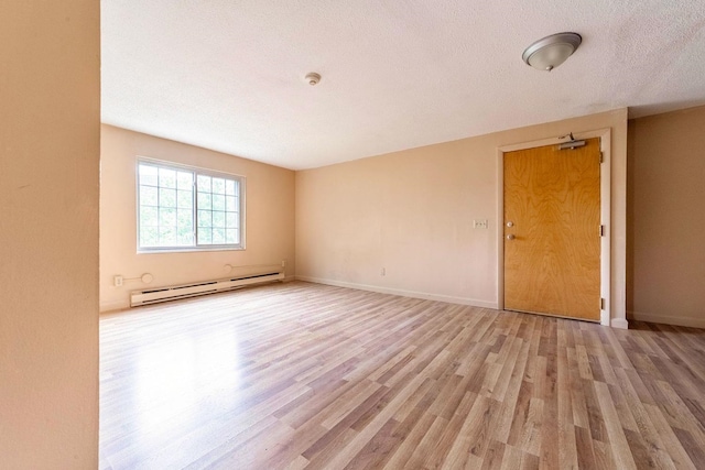 30 Beech St Unit 4B, Bristol, NH 03222 - unfurnished room with baseboard heating, light wood-style flooring, a textured ceiling, and a smoke detector