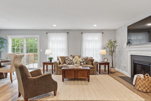 7A Terraceview Dr, Hudson, NH 03051 - living room featuring light wood-type flooring, recessed lighting, and a fireplace with flush hearth