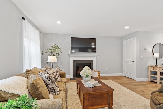 7A Terraceview Dr, Hudson, NH 03051 - living area with light wood-type flooring, a glass covered fireplace, and recessed lighting