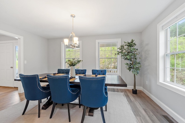 7A Terraceview Dr, Hudson, NH 03051 - dining room with healthy amount of natural light, wood finished floors, and a chandelier