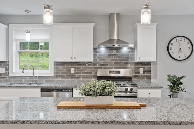 7A Terraceview Dr, Hudson, NH 03051 - kitchen featuring wall chimney exhaust hood, appliances with stainless steel finishes, white cabinets, light stone countertops, and decorative backsplash
