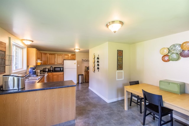 83 Tamworth Rd, Tamworth, NH 03886 - kitchen featuring freestanding refrigerator, black microwave, dark countertops, and a peninsula