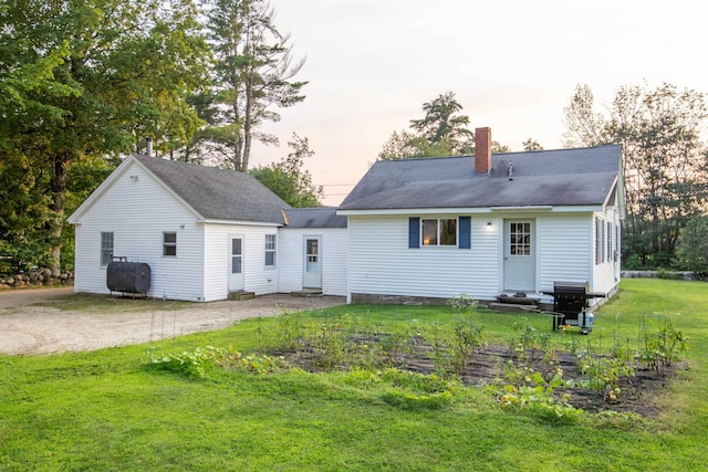 83 Tamworth Rd, Tamworth, NH 03886 - rear view of property with a chimney, heating fuel, driveway, and a yard