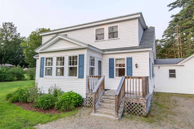 83 Tamworth Rd, Tamworth, NH 03886 - traditional home featuring a wooden deck, a front lawn, and roof with shingles