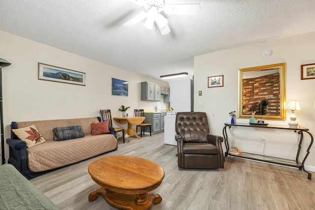 42 Wylie Ct Unit 6, Conway, NH 03860 - living area featuring light wood-type flooring, ceiling fan, and a textured ceiling