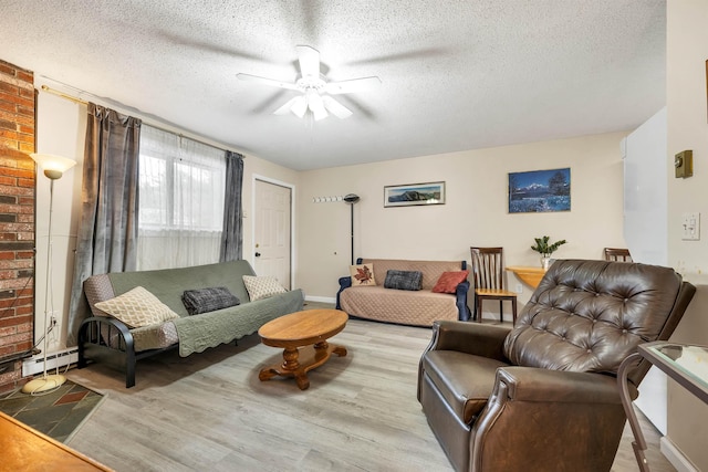 42 Wylie Ct Unit 6, Conway, NH 03860 - living area with a ceiling fan, a textured ceiling, wood finished floors, and a baseboard radiator