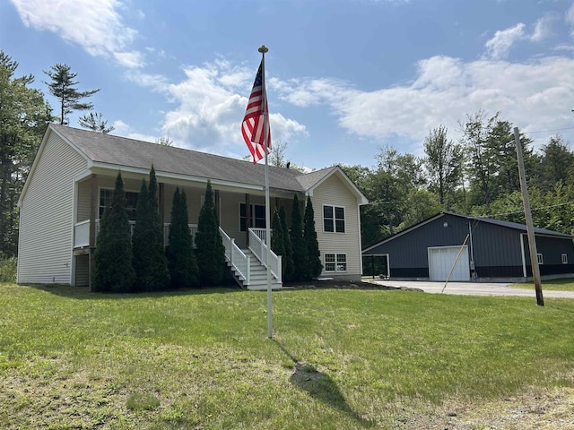 142 Eagle Shore Rd, Moultonborough, NH 03254 - view of front of property with a garage, an outbuilding, a front lawn, and a porch