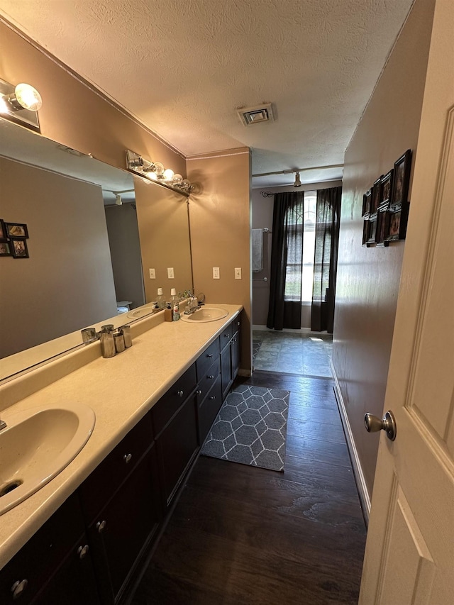 2 Cobblestone Pl, Merrimack, NH 03054 - full bath featuring a textured ceiling, double vanity, and wood finished floors