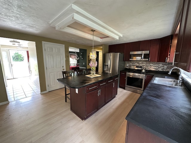 2 Cobblestone Pl, Merrimack, NH 03054 - kitchen featuring stainless steel appliances, dark countertops, plenty of natural light, and light wood-style floors