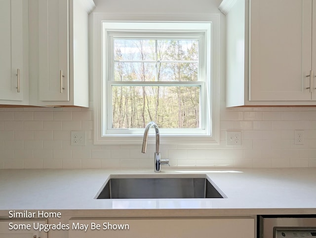 8 Meindl Rd Unit 1, Raymond, NH 03077 - kitchen featuring light countertops, beverage cooler, tasteful backsplash, and white cabinets
