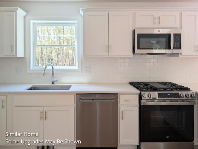 8 Meindl Rd Unit 1, Raymond, NH 03077 - kitchen featuring appliances with stainless steel finishes, white cabinets, and light countertops