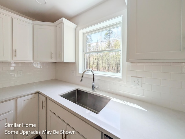 8 Meindl Rd Unit 1, Raymond, NH 03077 - kitchen featuring white cabinetry, tasteful backsplash, and light countertops