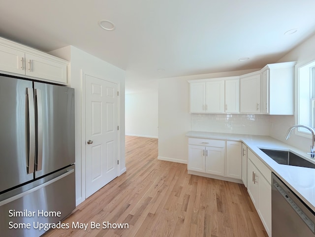 8 Meindl Rd Unit 1, Raymond, NH 03077 - kitchen featuring stainless steel appliances, white cabinets, backsplash, light wood-style flooring, and recessed lighting