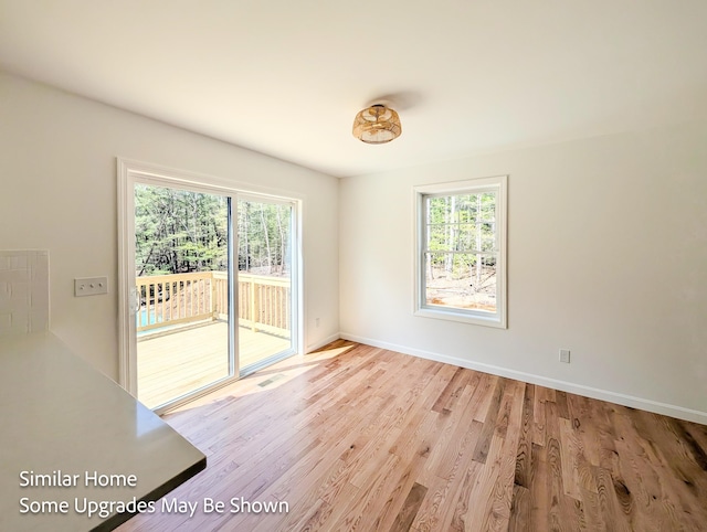 8 Meindl Rd Unit 1, Raymond, NH 03077 - unfurnished room with healthy amount of natural light and wood finished floors