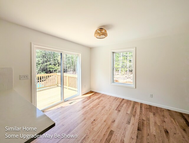 8 Meindl Rd Unit 1, Raymond, NH 03077 - unfurnished room with healthy amount of natural light and wood finished floors