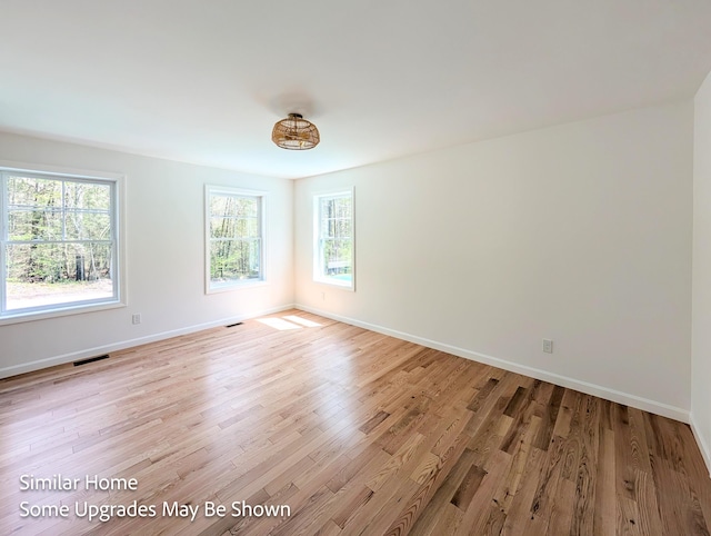 8 Meindl Rd Unit 1, Raymond, NH 03077 - empty room with light wood-style floors and baseboards