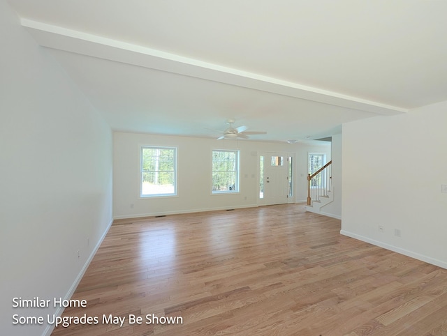 8 Meindl Rd Unit 1, Raymond, NH 03077 - unfurnished room with stairway, light wood finished floors, and a ceiling fan