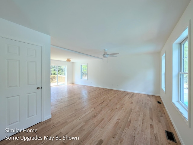 8 Meindl Rd Unit 1, Raymond, NH 03077 - unfurnished room with healthy amount of natural light, light wood finished floors, and ceiling fan