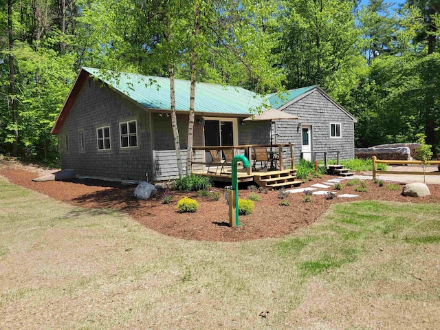 49 Tabor Cir, Albany, NH 03818 - view of front facade featuring a deck and a front lawn