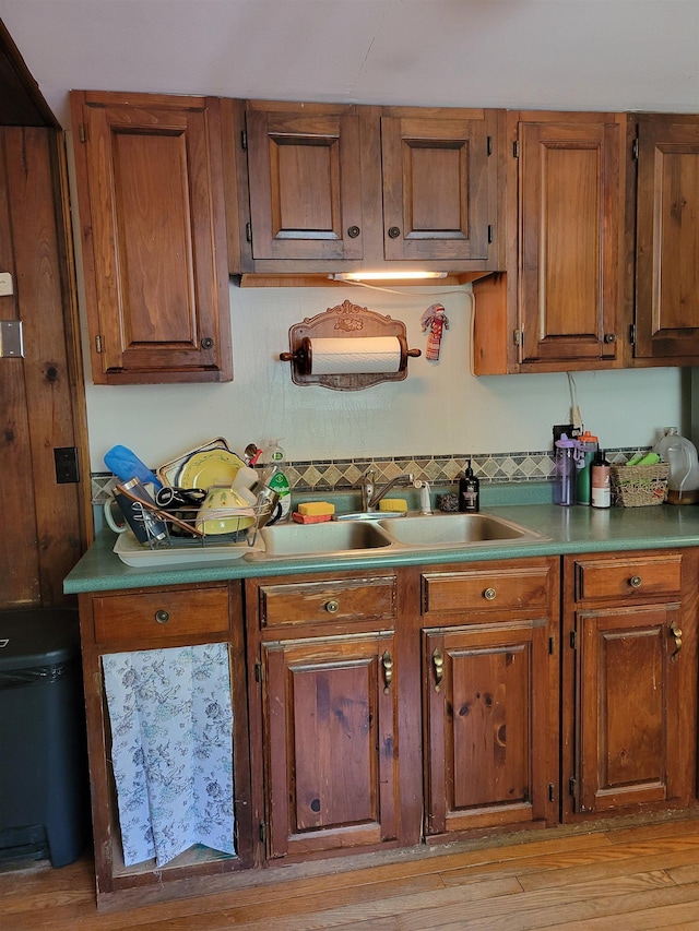 49 Tabor Cir, Albany, NH 03818 - kitchen with brown cabinetry, light wood finished floors, and tasteful backsplash