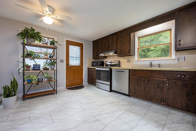 8 Jakes Ln, Merrimack, NH 03054 - kitchen featuring appliances with stainless steel finishes, plenty of natural light, under cabinet range hood, and dark brown cabinetry