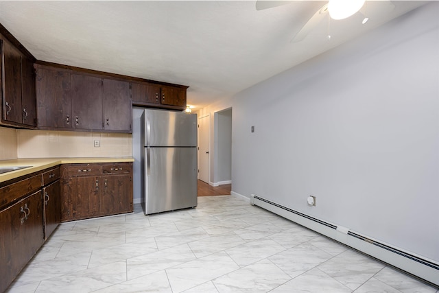 8 Jakes Ln, Merrimack, NH 03054 - kitchen with freestanding refrigerator, baseboard heating, light marble finish flooring, light countertops, and a ceiling fan