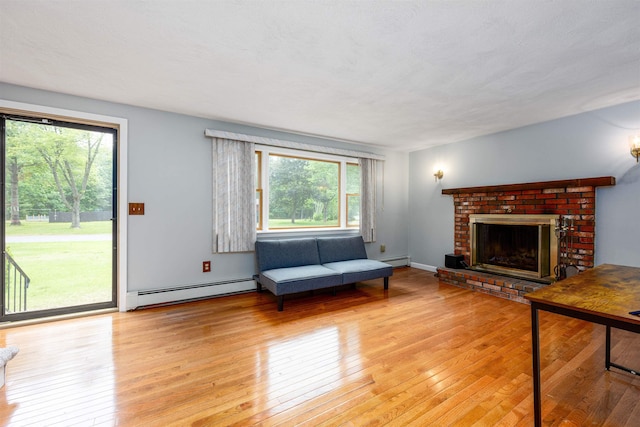 8 Jakes Ln, Merrimack, NH 03054 - living area with a baseboard radiator, hardwood / wood-style floors, and a fireplace