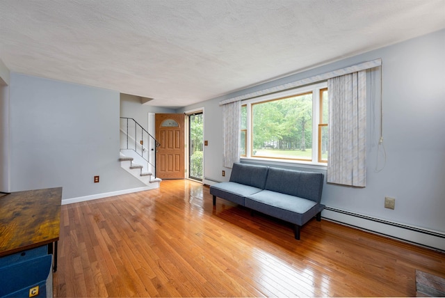 8 Jakes Ln, Merrimack, NH 03054 - entrance foyer with stairs, light wood-style flooring, and baseboard heating