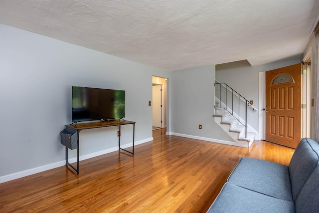 8 Jakes Ln, Merrimack, NH 03054 - living room with stairs, wood finished floors, and a textured ceiling