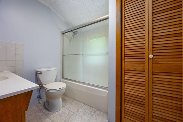 8 Jakes Ln, Merrimack, NH 03054 - full bath featuring lofted ceiling, vanity, bath / shower combo with glass door, a textured ceiling, and a closet