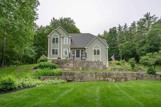35 Fletcher Ln, Hollis, NH 03049 - view of front of home featuring stucco siding, a front yard, and roof with shingles