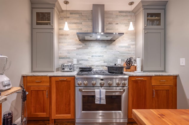 35 Fletcher Ln, Hollis, NH 03049 - kitchen with high end stove, wall chimney exhaust hood, tasteful backsplash, glass insert cabinets, and hanging light fixtures