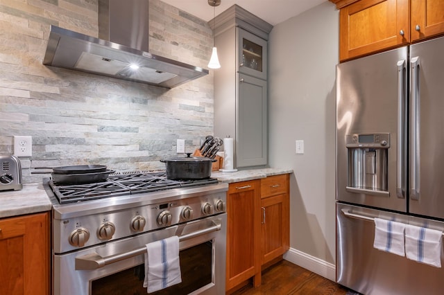 35 Fletcher Ln, Hollis, NH 03049 - kitchen with high end appliances, wall chimney exhaust hood, tasteful backsplash, dark wood finished floors, and brown cabinets