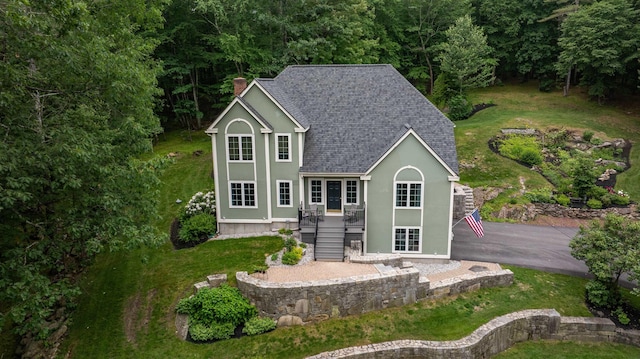 35 Fletcher Ln, Hollis, NH 03049 - rear view of property featuring stairs, stucco siding, roof with shingles, and a chimney
