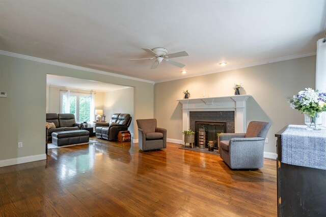 35 Fletcher Ln, Hollis, NH 03049 - living room with a ceiling fan, wood finished floors, a brick fireplace, and crown molding