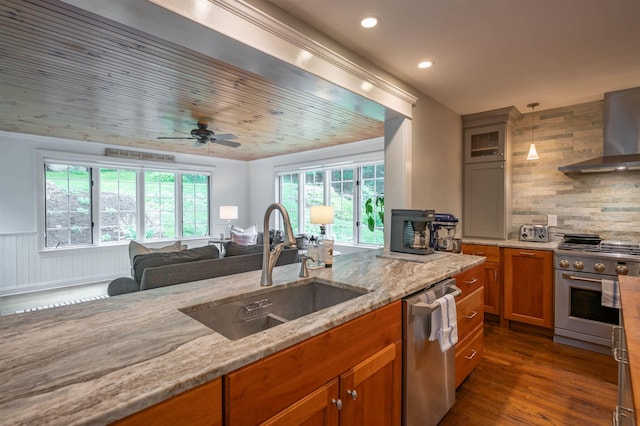 35 Fletcher Ln, Hollis, NH 03049 - kitchen with stainless steel appliances, wall chimney range hood, light stone countertops, dark wood finished floors, and tasteful backsplash
