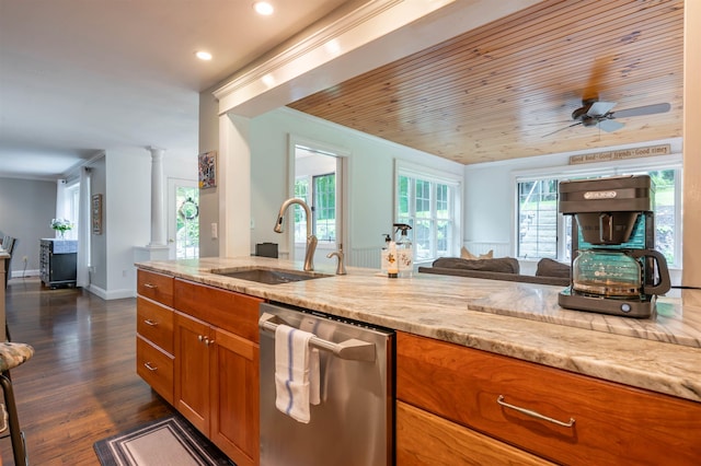35 Fletcher Ln, Hollis, NH 03049 - kitchen with dishwasher, brown cabinets, decorative columns, light stone counters, and open floor plan