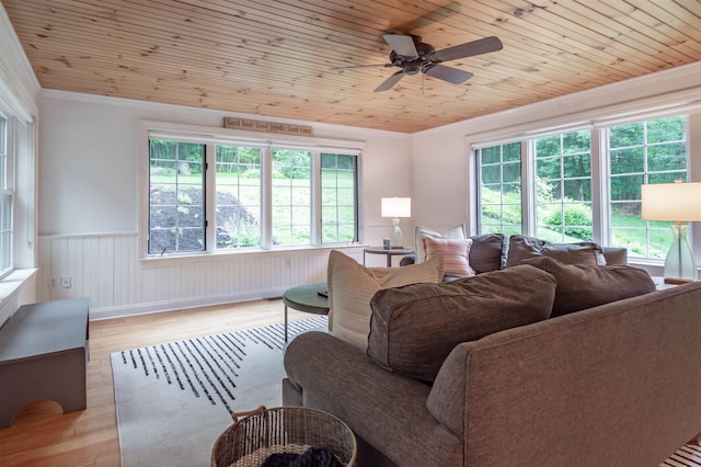 35 Fletcher Ln, Hollis, NH 03049 - living area featuring crown molding, a wainscoted wall, light wood-style flooring, healthy amount of natural light, and a ceiling fan