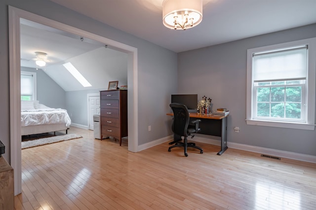 35 Fletcher Ln, Hollis, NH 03049 - bedroom with multiple windows, a skylight, light wood-type flooring, an office area, and lofted ceiling