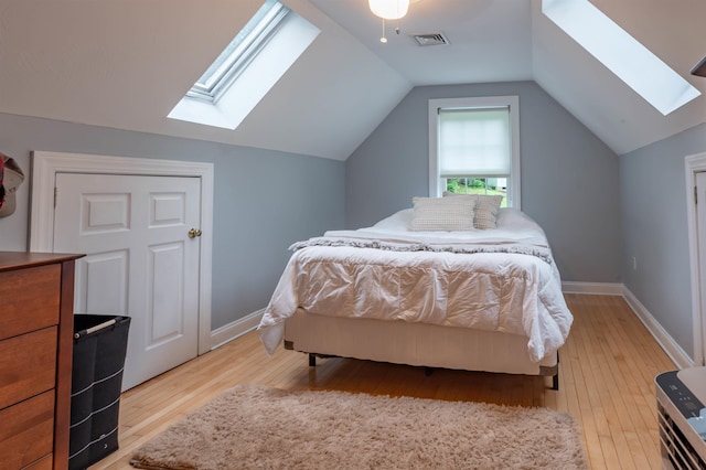 35 Fletcher Ln, Hollis, NH 03049 - bedroom with a skylight, light wood-style floors, lofted ceiling, and ceiling fan